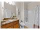 Well-lit bathroom with granite countertop vanity and a combined tub and shower at 1404 Palmer Hill Dr, Durham, NC 27703