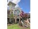 Beautiful clubhouse exterior featuring a clock tower and lovely landscaping at 1404 Palmer Hill Dr, Durham, NC 27703