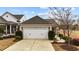Attached two-car garage with large driveway and manicured landscaping at 1404 Palmer Hill Dr, Durham, NC 27703