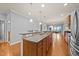 Large kitchen island with granite countertop, sink, and bar seating at 1404 Palmer Hill Dr, Durham, NC 27703