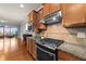 Modern kitchen featuring granite countertops, stainless steel appliances, and tile backsplash at 1404 Palmer Hill Dr, Durham, NC 27703
