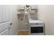 Bright laundry room with white washer and dryer and wire shelving for storage at 1404 Palmer Hill Dr, Durham, NC 27703