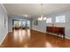 Bright living room featuring hardwood floors, blue accent wall, and elegant chandelier at 1404 Palmer Hill Dr, Durham, NC 27703