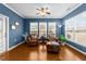 Comfortable living room with two leather chairs, an ottoman, and a ceiling fan at 1404 Palmer Hill Dr, Durham, NC 27703