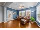 Comfortable living room with two leather chairs, an ottoman, and a ceiling fan at 1404 Palmer Hill Dr, Durham, NC 27703