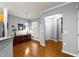 Bright home office area with desk, ample natural light, and hardwood floors at 1404 Palmer Hill Dr, Durham, NC 27703