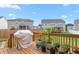 Spacious back deck with grill and flower pots offering an inviting outdoor space at 1415 Dalton Pl, Mebane, NC 27302