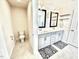 Bright bathroom featuring a toilet room, double sink vanity and decorative rugs at 1415 Dalton Pl, Mebane, NC 27302