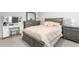 This bedroom features matching dresser and nightstand and neutral toned bedding at 1415 Dalton Pl, Mebane, NC 27302