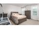 Bright bedroom includes large bed, dresser, and view of the outside at 1415 Dalton Pl, Mebane, NC 27302