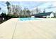 Beautiful community swimming pool with a bath house and surrounding woods at 1415 Dalton Pl, Mebane, NC 27302