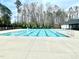 Large rectangular community pool with trees in background. Six lanes for lap swimming at 1415 Dalton Pl, Mebane, NC 27302