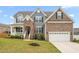 Charming two-story home boasts a combination of stone and siding, enhancing its curb appeal and architectural interest at 1415 Dalton Pl, Mebane, NC 27302