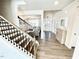 Bright foyer with hardwood floors, coffered ceilings, and decorative staircase at 1415 Dalton Pl, Mebane, NC 27302