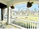Inviting front porch offers neighborhood views, with hanging flowers and comfortable seating for relaxation and enjoyment at 1415 Dalton Pl, Mebane, NC 27302