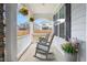Relaxing front porch featuring rocking chairs, hanging flower baskets, and a view of the neighborhood, perfect for enjoying outdoors at 1415 Dalton Pl, Mebane, NC 27302