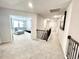 Hallway with staircase leading to a living room featuring a comfy gray sectional at 1415 Dalton Pl, Mebane, NC 27302