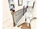 Upstairs hallway view with wood and iron banister overlooking the staircase and adjacent bedrooms at 1415 Dalton Pl, Mebane, NC 27302