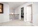 Bright hallway with carpeted floors, decorative railing, and open doorway to bedroom at 1415 Dalton Pl, Mebane, NC 27302