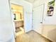Hallway leading to a bathroom featuring neutral-colored walls and carpeted floors at 1415 Dalton Pl, Mebane, NC 27302