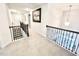 Bright hallway with staircase featuring decorative iron railings and neutral carpeting at 1415 Dalton Pl, Mebane, NC 27302