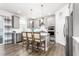 Modern kitchen featuring gray cabinets, stainless steel appliances, and island seating at 1415 Dalton Pl, Mebane, NC 27302