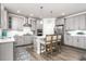 Bright kitchen with gray cabinets, stainless steel appliances, and island seating at 1415 Dalton Pl, Mebane, NC 27302