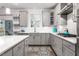 Modern kitchen featuring gray cabinets, island seating, and stainless steel appliances at 1415 Dalton Pl, Mebane, NC 27302