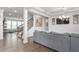 Bright living room featuring hardwood floors, modern lighting, and a staircase at 1415 Dalton Pl, Mebane, NC 27302