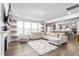 Inviting living room with a comfortable sectional sofa, accent rug, and large windows for natural light at 1415 Dalton Pl, Mebane, NC 27302