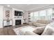 Bright living room featuring a fireplace, built-in cabinets, and large windows, creating an inviting space at 1415 Dalton Pl, Mebane, NC 27302