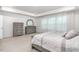 Neutral bedroom with gray furnishings, carpet, and tray ceiling with natural light coming through windows at 1415 Dalton Pl, Mebane, NC 27302