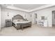 Spacious main bedroom with tray ceiling, elegant furniture, and access to a bathroom creating a relaxing retreat at 1415 Dalton Pl, Mebane, NC 27302