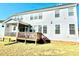 Back of home with a wooden deck, lots of windows, and light grey siding at 1415 Dalton Pl, Mebane, NC 27302