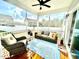 Cozy screened porch with wicker furniture, a ceiling fan, and views of the backyard at 1415 Dalton Pl, Mebane, NC 27302
