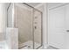 Modern bathroom featuring a glass enclosed shower with tiled walls and a built-in shower caddy at 1415 Dalton Pl, Mebane, NC 27302