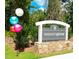 A neighborhood sign for Weavers Grove on a stone base with colorful balloons nearby at 146 Weavers Grove Dr, Chapel Hill, NC 27514