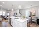 Bright, open kitchen with a large island, stainless steel appliances, and seamless flow to living and dining areas at 146 Weavers Grove Dr, Chapel Hill, NC 27514