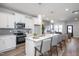 Modern kitchen featuring a spacious island with bar seating, stainless steel appliances, and open layout to the living area at 146 Weavers Grove Dr, Chapel Hill, NC 27514