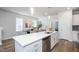 Spacious kitchen island with bar seating and modern appliances with an open layout to the dining area at 146 Weavers Grove Dr, Chapel Hill, NC 27514