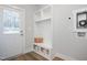 Convenient mudroom with built-in storage, seating, and access to the outdoors and laundry at 146 Weavers Grove Dr, Chapel Hill, NC 27514
