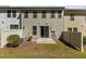 View of the back of the townhome with a sliding glass door and small yard at 150 Alamosa Pl, Cary, NC 27519