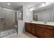 Bathroom featuring a glass enclosed shower, double sink vanity, and neutral tiling at 150 Alamosa Pl, Cary, NC 27519