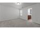 A spacious bedroom with neutral walls and carpet adjacent to bathroom entrance at 150 Alamosa Pl, Cary, NC 27519