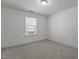 A simple bedroom with white walls, carpet, and a window, offering a clean and bright space at 150 Alamosa Pl, Cary, NC 27519