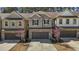 Lovely townhome featuring gray siding, a brick-accented garage, and beautiful flowering trees at 150 Alamosa Pl, Cary, NC 27519