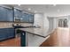Stylish kitchen featuring an island with granite countertops, stainless appliances, and blue cabinets at 150 Alamosa Pl, Cary, NC 27519