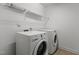 Laundry room featuring a side-by-side washer and dryer with overhead shelving at 150 Alamosa Pl, Cary, NC 27519