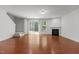 Spacious living room with hardwood floors, a fireplace, and sliding glass doors to the outdoors at 150 Alamosa Pl, Cary, NC 27519