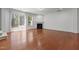 Bright living room featuring hardwood flooring, a cozy fireplace, and sliding glass doors at 150 Alamosa Pl, Cary, NC 27519
